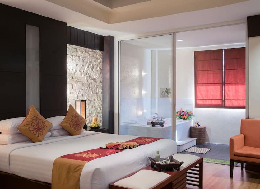 Palette Bangkok Natural Resort and Spa in Bangkok, a bedroom with king bed, seating area and sliding glass doors