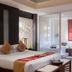 Palette Bangkok Natural Resort and Spa in Bangkok, a bedroom with king bed, seating area and sliding glass doors