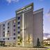 TownePlace Suites by Marriott Naples exterior at dusk with palm trees and a modern multi-story facade
