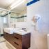 Il Mondo Boutique Hotel Brisbane bathroom with glass shower, vanity and tiled walls