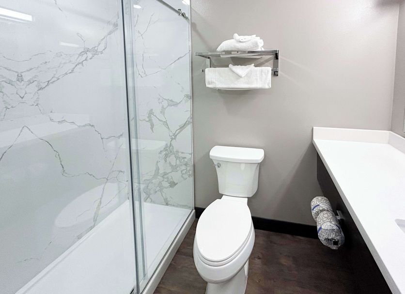 Studio 6 Corona. Ca-West bathroom with glass shower, toilet and vanity in Corona