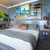 La Casa del Camino Laguna Beach guest room with king bed, surfboard wall art, and ocean-inspired decor