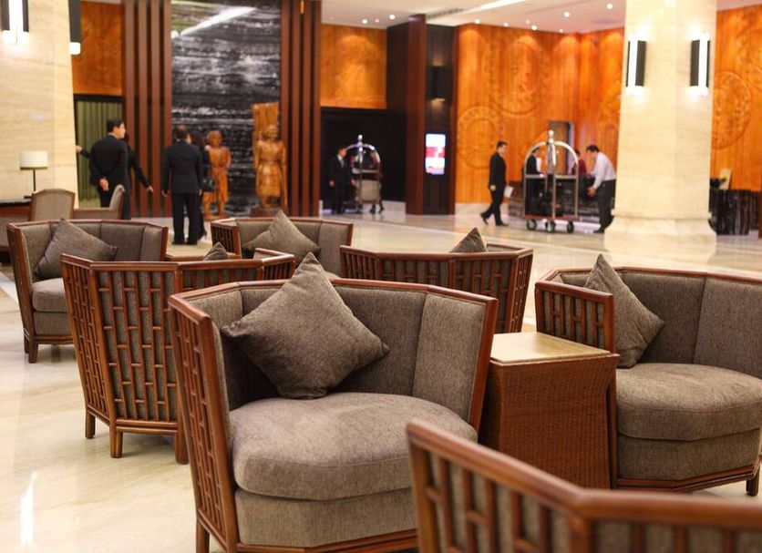 Fullon Hotel Hualien lobby lounge in Hualien City with wicker armchairs and warm wood paneling