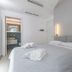 Malù Bed&Breakfast in Polignano a Mare, bright minimalist bedroom with double bed and ensuite doorway
