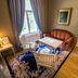 Karolineburg Manor House Hotel in Kajaani: cozy seating area with sofa, table, chairs, window, and patterned rug