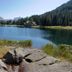 Hotel Pinzolo-Dolomiti in Pinzolo overlooking a calm alpine lake with pine forest and mountains