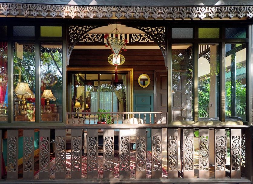 Thai Thai Sukhothai Resort in Sukhothai with ornate wooden veranda and lush garden views