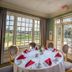 Pawleys Plantation Golf & Country Club dining room with round table, red napkins, and golf course views in Pawleys Island