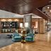 The Rally Hotel at McGregor Square in Denver lobby lounge with long communal table and teal chairs