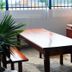 Hotel Sao Charbel in Ubatuba outdoor terrace with wooden table, benches and brick barbecue grill