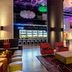Aloft Panama in Panama City lounge with colorful ceiling lights, bar seating, and modern lounge chairs