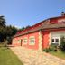 Arena Surf Hotel in Somo, red-roofed hotel exterior with stone path and garden