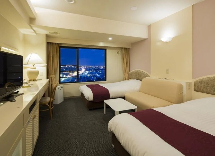 Asahikawa Park Hotel room with twin beds and city view at night in Asahikawa