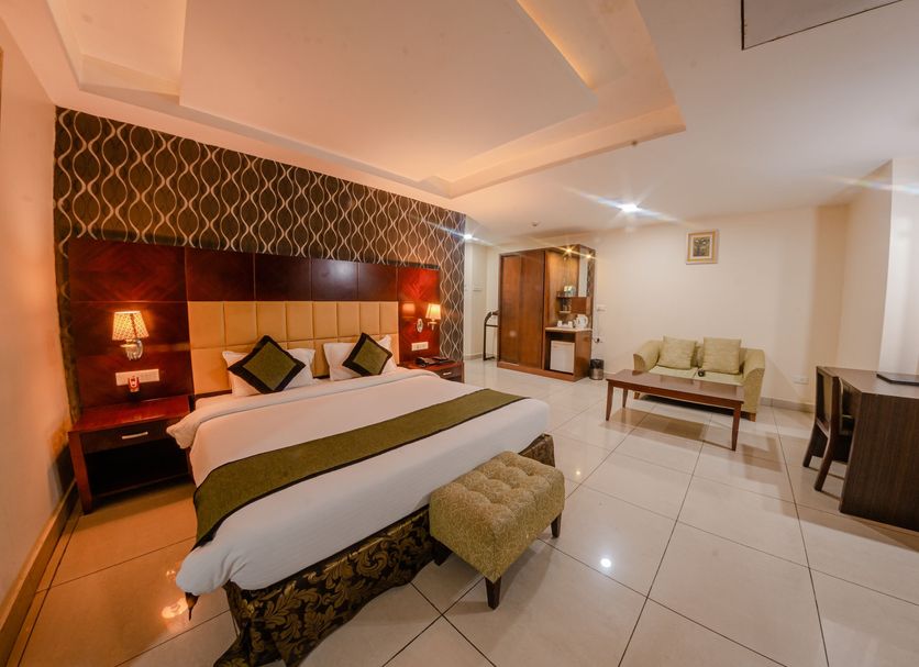 Hotel Gateway Grandeur, Guwahati guest room with king bed, seating area, and work desk