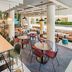 Ibis Styles Wien City Vienna lobby café with tables, bar stools, and hanging pendant lights