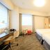Richmond Hotel Tokyo Suidobashi room with two beds, desk, window seat and ottoman in Tokyo