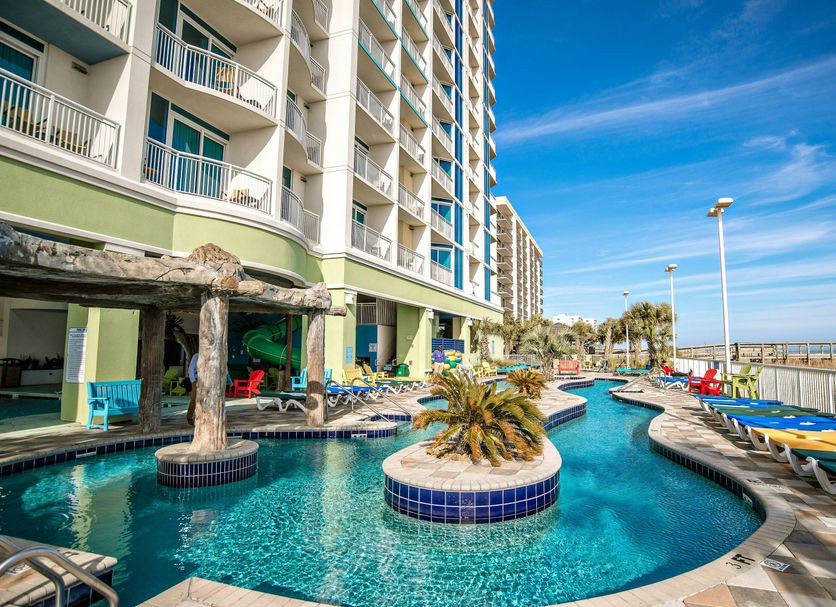 Towers at North Myrtle Beach pool area with lazy river, loungers, and oceanfront deck