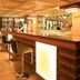 Lotos Inn & Suites, Nairobi bar lounge with counter stools and large windows overlooking Nairobi