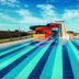 Tui Magic Life Jacaranda, Side: outdoor lap pool with colorful water slides and sun loungers