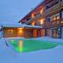 Landhotel Moorhof in Neuschönau with outdoor pool surrounded by snow at dusk