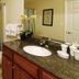 Crystal Towers Gulf Shores bathroom with granite vanity, sink, shower curtain and toilet