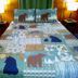Evening Shade River Lodge & Cabins in Chimney Rock, bear-themed quilted bed with lamps and wood-paneled walls