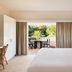 Atlantic Byron Bay in Byron Bay room with open curtains to a private balcony and garden view
