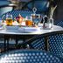 The Relais Cooden Beach in Bexhill-on-Sea: outdoor table set with breakfast and drinks on a terrace