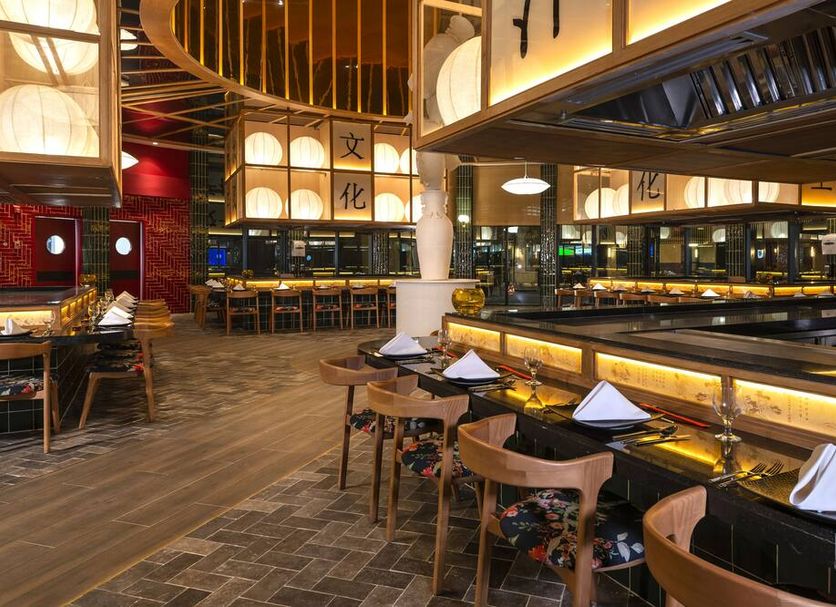 Ocean Coral Spring in Falmouth: Asian-style restaurant interior with sushi bar seating and warm lighting
