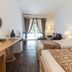 Nata Beach Villa in Ishigaki guest room with two beds, desk, and balcony doors