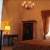 Masseria Magli Resort room in Martina Franca with arched ceiling, chandelier, and draped window