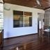 Otro Lado Lodge And Restaurant Santa Teresa open-air dining deck with wooden table and jungle view