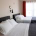 The Marquette Hotel in Madison guest room with two beds beside a bright window
