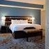 Fairfield Inn & Suites by Marriott Houston North/Spring guest room with king bed and bench