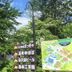 Onsen Yupopo in Semboku with Japanese signposts and a map beside lush trees outdoors