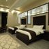 Safir Hotel in Dushanbe guest room with two beds, seating area, TV, and patterned rug