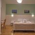 Bel Sole Civitavecchia guest room with double bed, bedside lamps, desk chair and nautical wall art