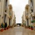 Zifan Hotel & Suites in Karachi with a wet courtyard walkway between cream-colored hotel buildings
