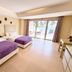 The Muse Beach Front Hotel Boracay room with two beds and sliding doors to a beach-view balcony