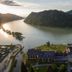 Riverresort Donauschlinge in Haibach ob der Donau with river bend, forested hills and lakeside hotel