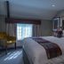 The Carpenters Arms Bristol guest room with king bed, tufted headboard, window light and armchair