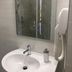 Piccolo in Lamezia Terme bathroom sink with mirror, wall-mounted hair dryer and glass shower