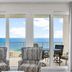 Laketown Wharf 1712 in Panama City Beach, oceanview balcony with chairs and floor-to-ceiling glass doors