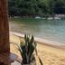 Pousada Frezza Mergulho in Angra dos Reis with a sandy beach, calm bay, and boats offshore