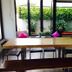 Vanilla Residence Chiangmai, Chiang Mai: dining area with wooden table, benches and garden view