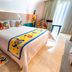 Four Points by Sheraton Barranquilla guest room with colorful bed runner and bright chair