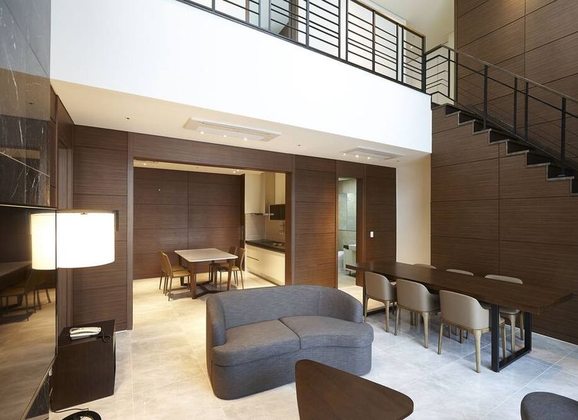 Hotel Around Pyeongchang lobby lounge with staircase, seating area and dining table in Pyeongchang