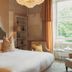 No 15 by GuestHouse, Bath bedroom with canopy bed, chandelier, and window seat