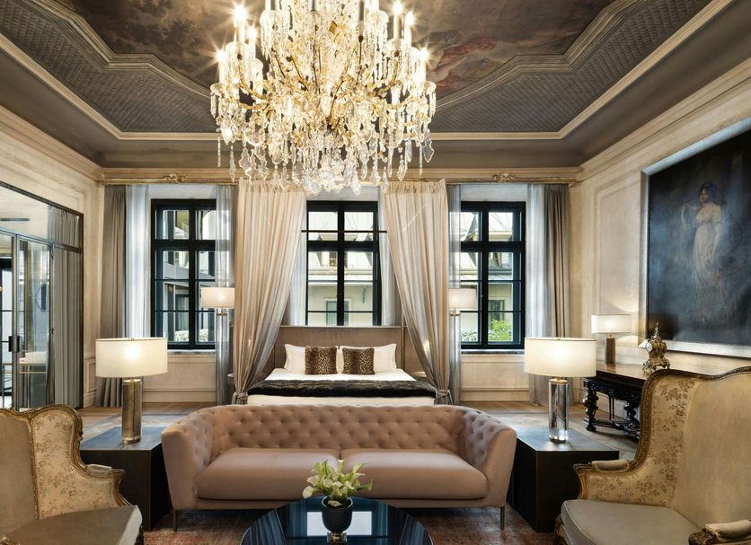 H15 Palace, a Luxury Collection Hotel, Krakow suite with crystal chandelier, tufted sofa and large windows