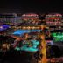 Night view of Orange County Belek in Belek with illuminated pools and resort buildings
